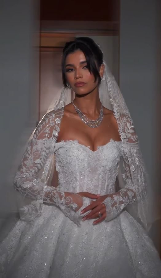 Bride in a lace gown, hair and veil finished